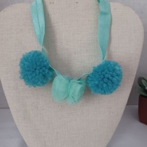 Girls Headband with pompoms.